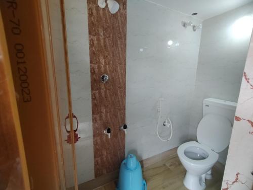 a small bathroom with a toilet and a shower at Megh Balika Santiniketan Family Homestay, The Best Homestay in Santiniketan in Shānti Niketan