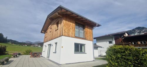 a small house with a wooden roof on top of it at Haus Alpengruss in Heiterwang