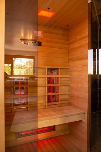 a sauna with a bench in a wooden room at Villa Sunshine in Sremska Kamenica