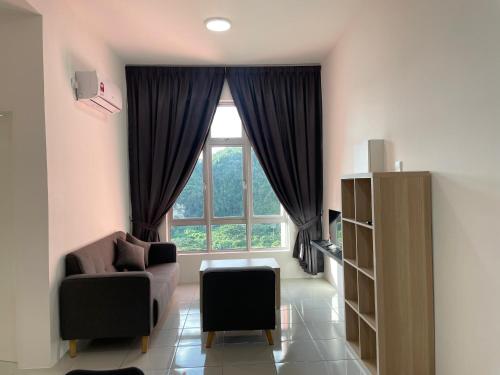 a living room with a chair and a window at the Anderson Ipoh 2BR by Goswell in Ipoh