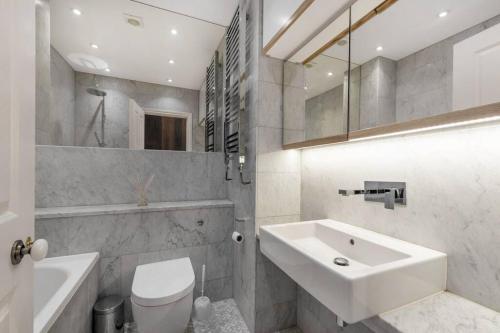 a white bathroom with a sink and a toilet at Museum View in London
