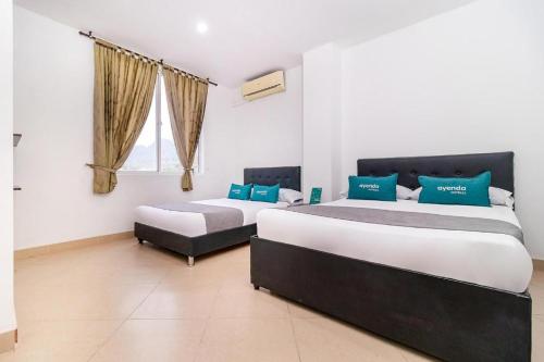a bedroom with two beds and a window at hotel iguazu yopal in Yopal