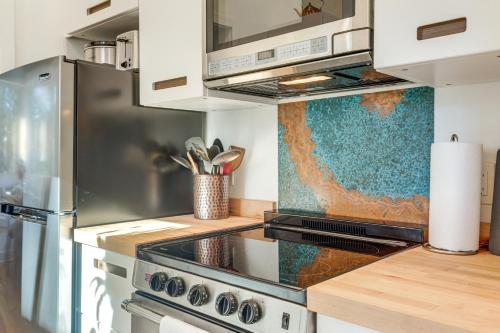 a kitchen with a stainless steel stove top oven at Private Hot Tub Waterfront Home along Eagle River in Eagle River