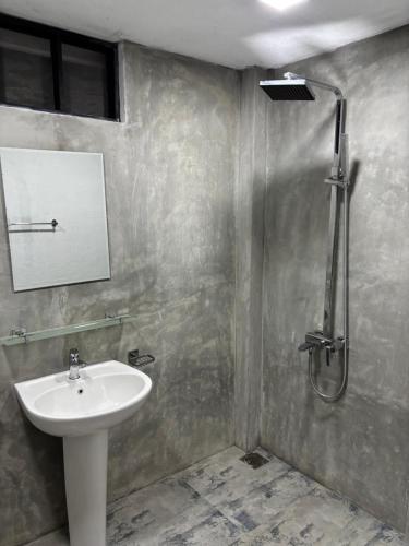 a bathroom with a sink and a shower at Ima House in Hiriketiya