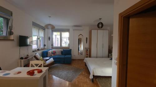 a living room with a bed and a couch at Apartman BelLe in Belgrade