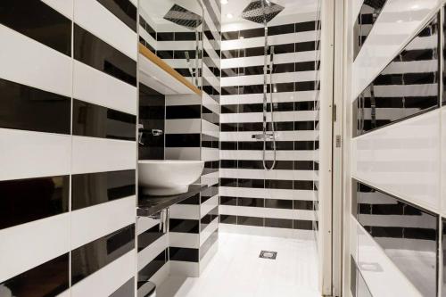 a bathroom with a black and white striped wall at Sherlocks in London