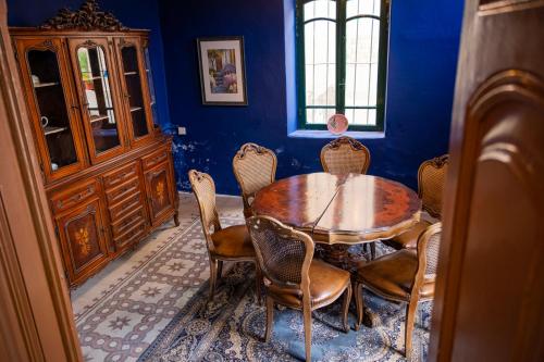 a dining room with a wooden table and chairs at Central house with beautiful garden in Amman