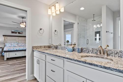 a bathroom with two sinks and a large mirror at It's Nautical Nonsense Oceanview 4 bedroom, 4 bath in Pawleys Island