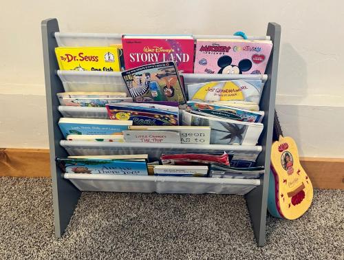 a book shelf filled with books and textbooks at Grand Teton Paradise Unmatched Views Hot Tub in Driggs