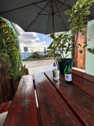 a wooden table with two bottles of wine on it at The Legacy BnB in East London