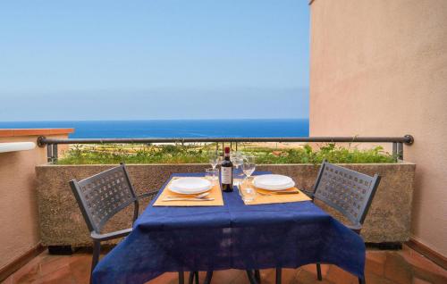 a table with a blue table cloth and a bottle of wine at Mono 2 in Lido di Mondello