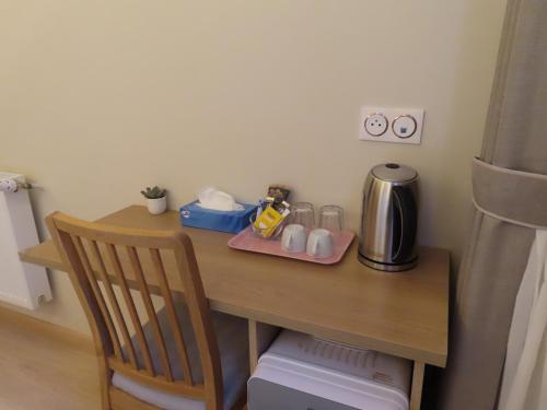 a table with a coffee maker on it next to a refrigerator at Chambre à Bondy pour deux personnes in Bondy