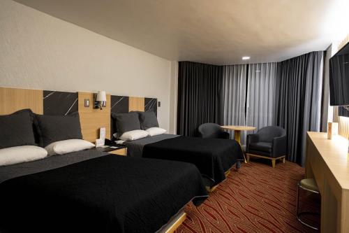 Postel nebo postele na pokoji v ubytování Hotel Real Plaza