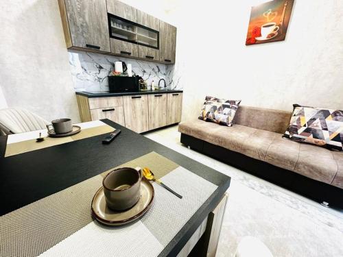 a living room with a coffee table and a couch at Жк Панель центр in Fëdorovka