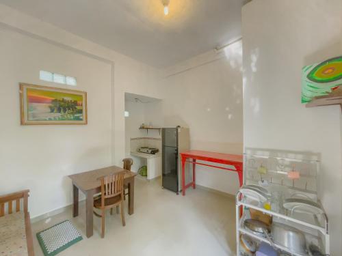 a small kitchen with a table and a refrigerator at Surya Ubud View and Suites by EPS in Ubud