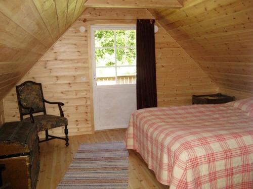 a bedroom with a bed and a window in a cabin at Stunning Home In Hörby With 3 Bedrooms in Hörby