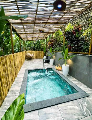 a swimming pool with a pergola and a swimming poolvisor at Arenal Nest in San Francisco