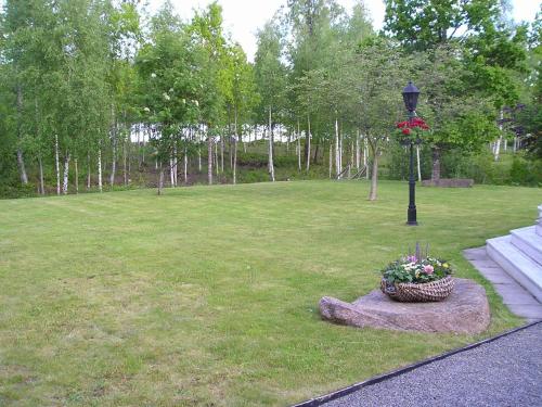 a park with a lamp post and a basket of flowers at Amazing Home In Värnamo With 2 Bedrooms in Värnamo
