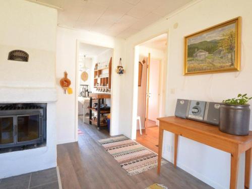 a living room with a fireplace and a clock on a table at Stunning Home In Oskarshamn With 2 Bedrooms And Wifi in Oskarshamn