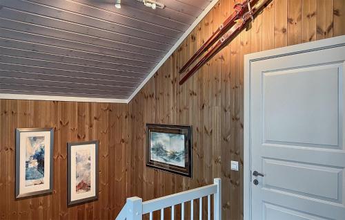 a room with wooden walls and a white door at Amazing Home In Oppdal in Oppdal