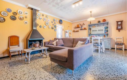 a living room with a couch and a fireplace at Awesome Home In Sant Miquel De Fluvià in San Miguel de Fluviá