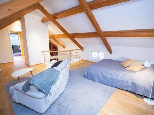 a bedroom with a bed and a chair at Nice Home In Vessigebro With 2 Bedrooms And Wifi in Vessigebro