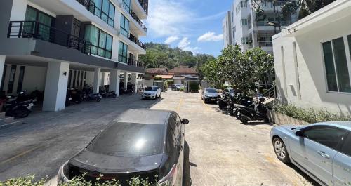 a car parked on a street next to a building at Royal Kamala - 1 separated bedroom Condo in Kamala Beach