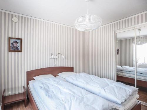 a bedroom with a large white bed and a mirror at Awesome Home In Åseda With 2 Bedrooms And Wifi in Åseda