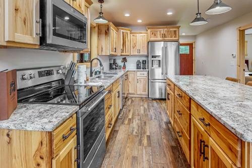 a kitchen with wooden cabinets and stainless steel appliances at Duck Lake Escape in Eagle River