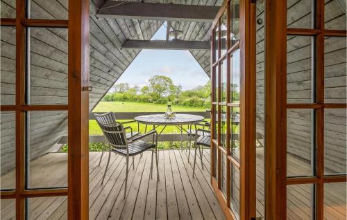 a view of a porch with a table and chairs at Awesome Home In Nordborg With Sauna in Nordborg