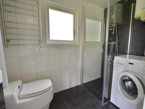 a bathroom with a toilet and a washing machine at Nice Home In Tvååker With 0 Bedrooms in Tvååker