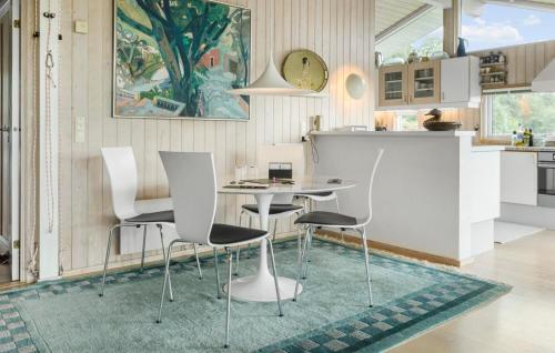 a kitchen with a table and chairs on a rug at Pet Friendly Home In Hornbæk With Wifi in Hornbæk