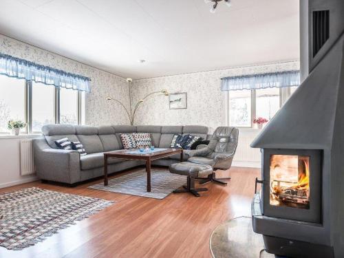 a living room with a couch and a fireplace at Awesome Home In Åseda With 2 Bedrooms And Wifi in Åseda