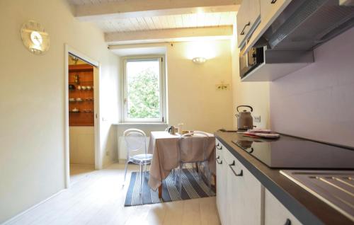 a kitchen with a table and a chair in it at 3 Bedroom Stunning Apartment In Massa in Massa