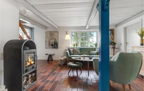 a living room with a fireplace and a couch at Awesome Home In Nordborg With Sauna in Nordborg