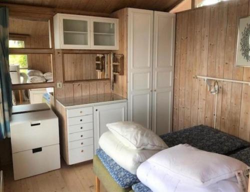 a small room with a bed and a kitchen at Amazing Home In Hälsö With 0 Bedrooms in Hälsö