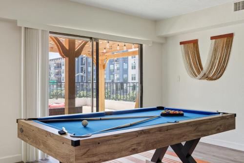 a pool table in a living room with a pool at Penthouse Free Parking Pool Table Private Balcony in Phoenix