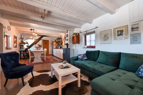 a living room with a green couch and a table at Kuća za odmor Freya in Krapinske Toplice