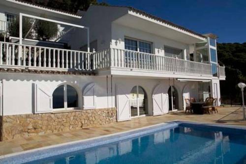 a house with a swimming pool in front of it at House Seaviews Barcelona 22Km in Cabrils