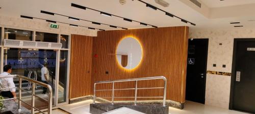 a wall with a sign on it in a building at Paragon Hotel Apartments in Abu Dhabi