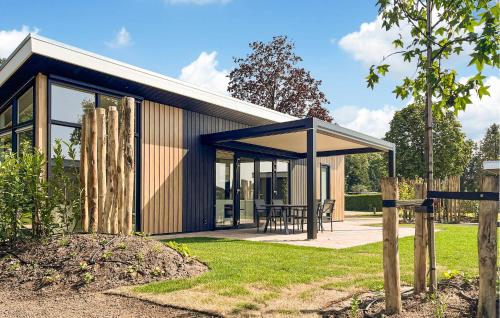 a small house with glass doors and a patio at 2 Bedroom Gorgeous Home In Voorthuizen in Voorthuizen