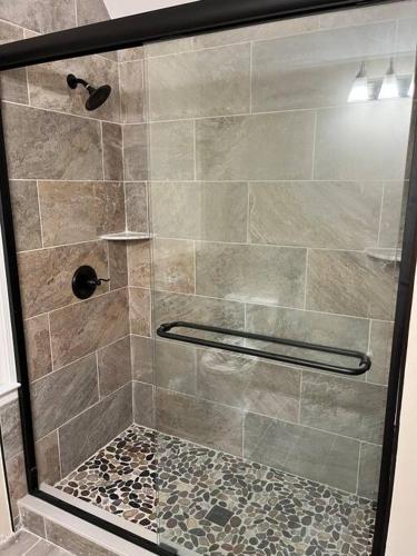 a shower with a glass door in a bathroom at Helen, GA Bear Paw Haus 4 bdrm, sleeps 10, fire pit, pool table, on Golf course in Helen