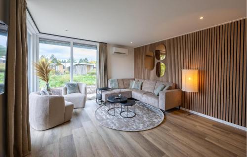 a living room with a couch and a table at 2 Bedroom Gorgeous Home In Voorthuizen in Voorthuizen