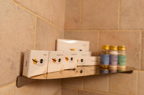a shelf in a bathroom with boxes on it at Solo Inn By Hawk Hospitality in Cochin