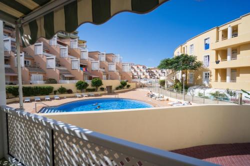 a balcony with a view of a pool and buildings at Orlando 85 Complex - Costa Adeje in Adeje