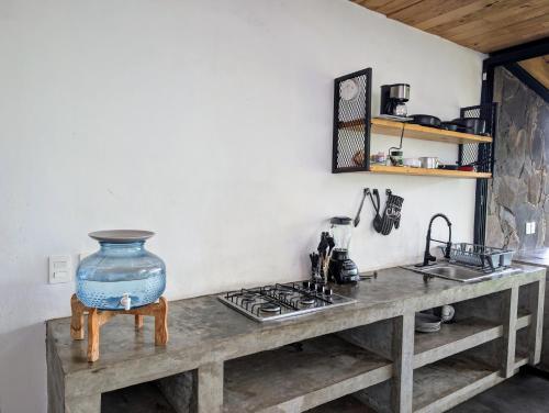 a kitchen counter with a large blue vase on top of it at Cabaña La Finca Mazamitla in Mazamitla