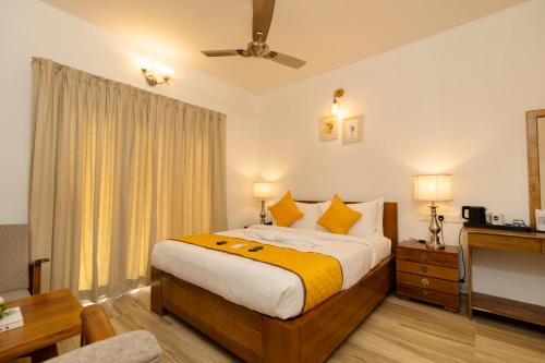 a hotel room with a bed and a television at Solo Inn By Hawk Hospitality in Cochin