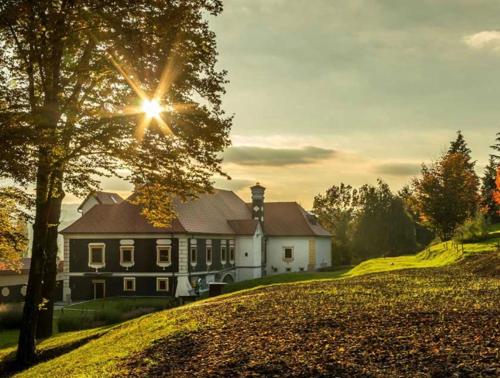 a house on a hill with the sun shining on it at Kuća za odmor Freya in Krapinske Toplice