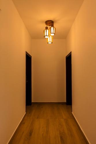an empty room with a chandelier at Solo Inn By Hawk Hospitality in Cochin