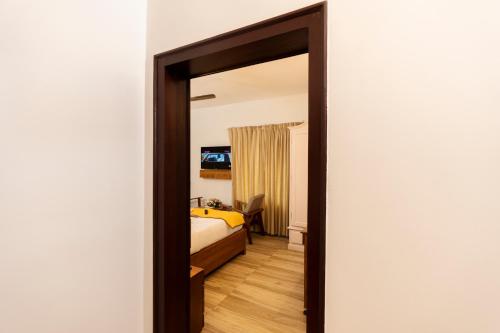 a bedroom with a bed and a mirror in a room at Solo Inn By Hawk Hospitality in Cochin
